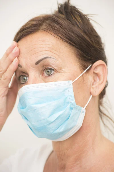 Tired nurse with mask over face — Stock Photo, Image