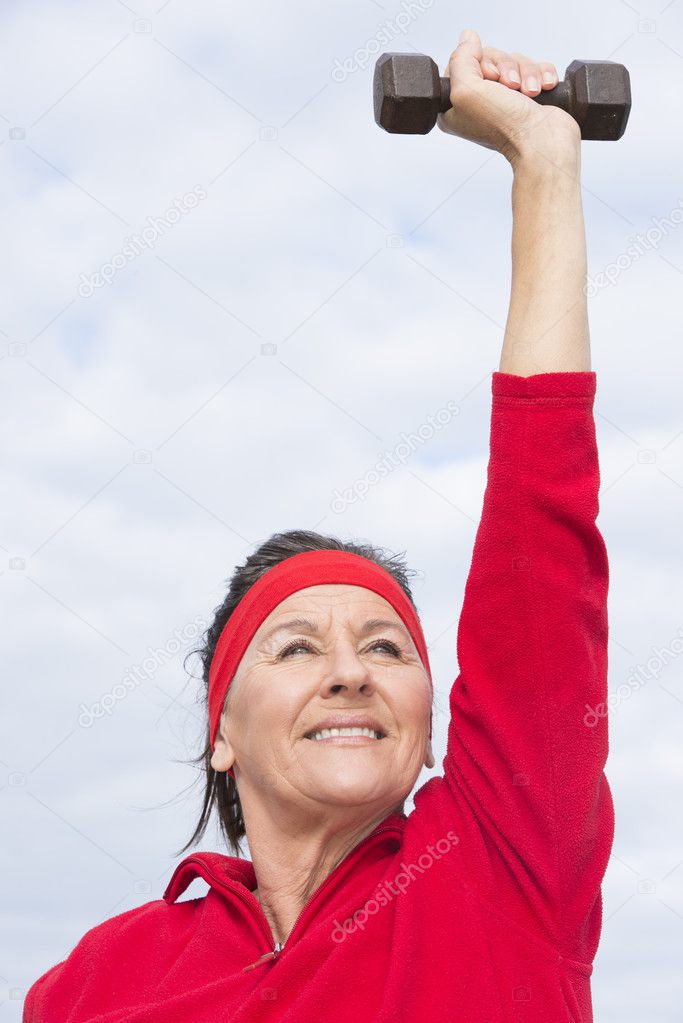 Positive successful mature woman exercising