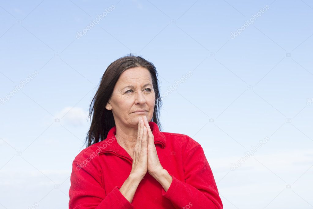 Concerned thoughtful woman praying hands