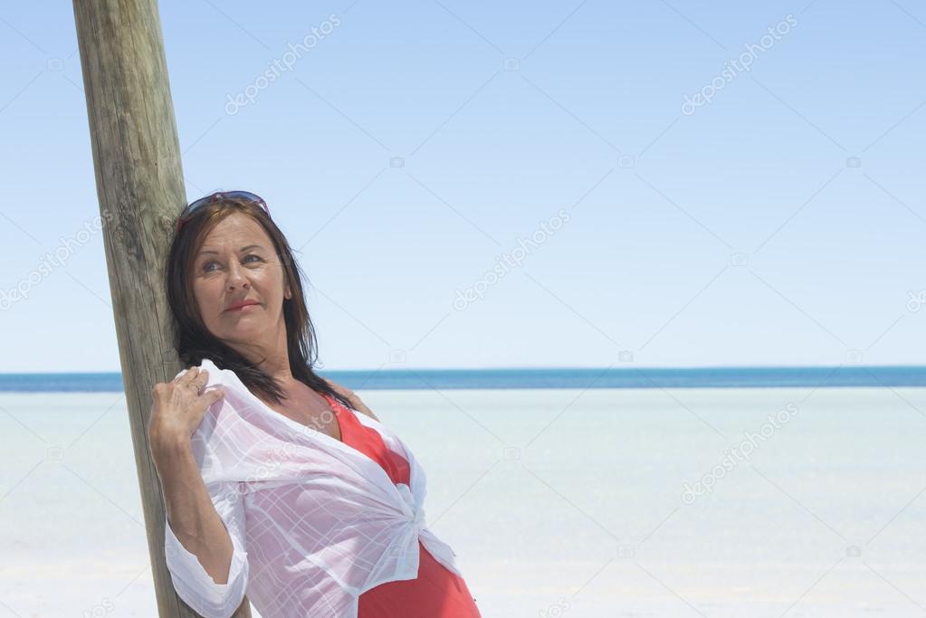 Sexy mature woman beach holiday