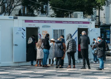 Lisbon, Portugal - January 5, 2022 People queue for a free Covid test on Rossio Square in Lisbon, Portugal. Portugal experienced a rise of over 25,000 cases on Jan 4 mainly due to the Omicron variant