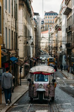 Lisbon, Portugal - January 5, 2022: Tuk Tuk at Rua da Conceicao in the Baixa neighbourhood