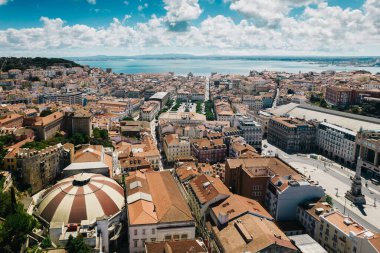 Aerial drone view of Baixa District in Lisbon, Portugal with major landmarks visible, next to the Tagus River