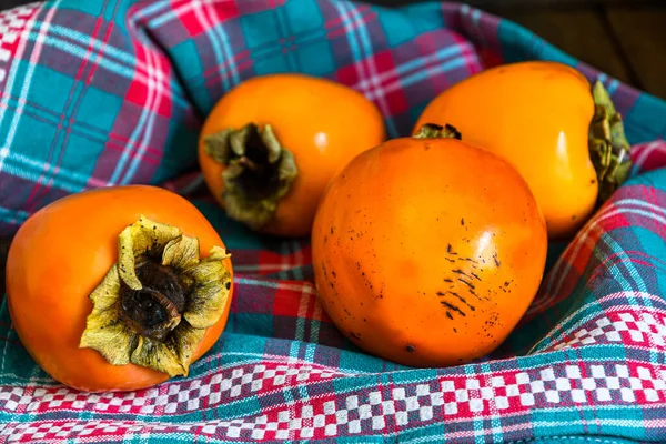 Ripe Persimmons Lie Kitchen Napkin Wooden Kitchen Table — Stock Photo, Image