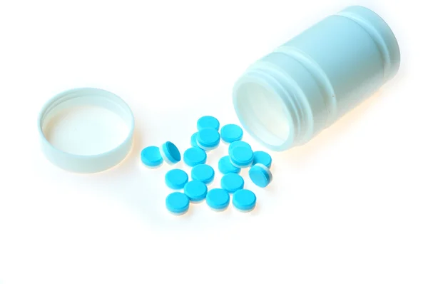 Blue pills scattered — Stock Photo, Image