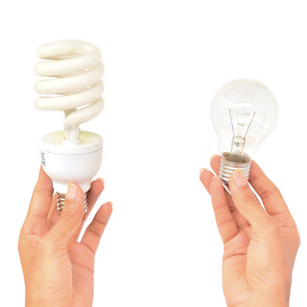 Hands holding traditional and energy efficent lightbulbs