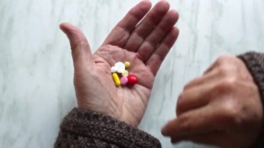 Yaşlı kadın eli haplı..