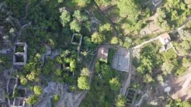 Drone top view abandoned village with stone houses without roofs in Kotor bay
