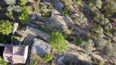 Aerial drone shot of an abandoned village on a hill with stone houses.Top aerial view spining