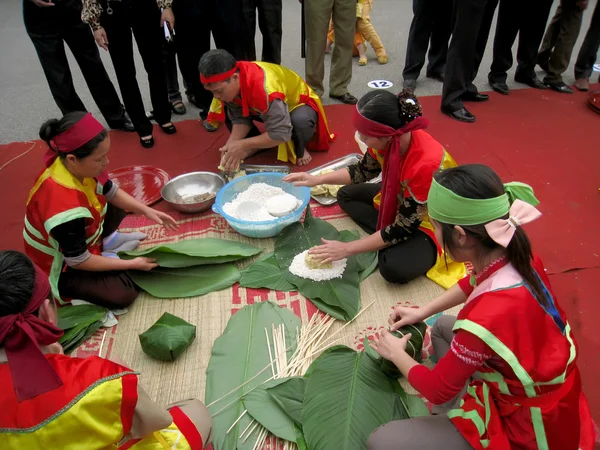 Pessoas no exame de traje tradicional para fazer arroz glutinoso quadrado — Fotografia de Stock