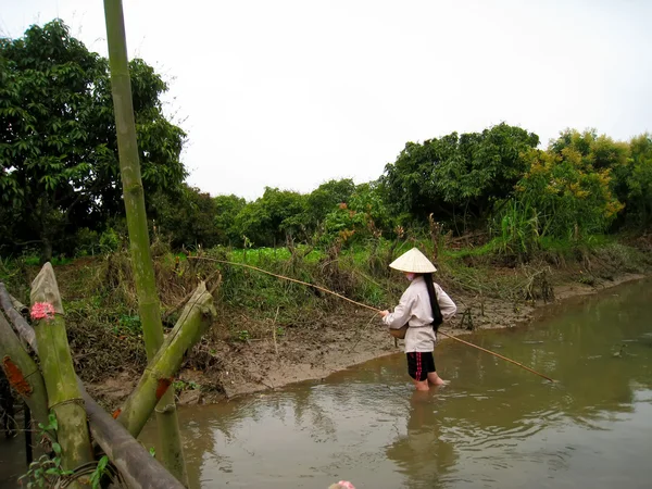 Rural chica uso caña de pescar con cebo cacht cangrejo en su agujero — Foto de Stock