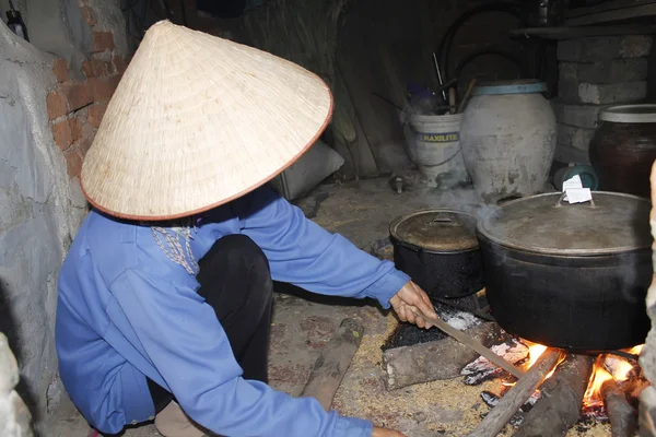 Asiatisk kvinne som koker riskake – stockfoto