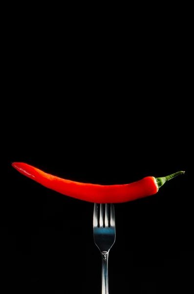 Red hot chilli pepper on fork — Stock Photo, Image
