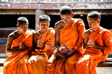 An unidentified monk teaching young novice monks clipart