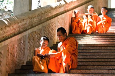 An unidentified monks teaching young novice monks clipart