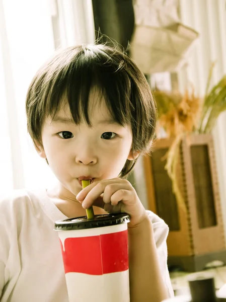 Asian boy drinking ice green tea — Stock Photo, Image