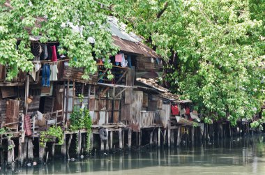 Slum on dirty canal clipart