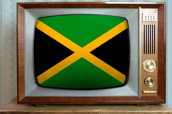 テレビ 世界貿易 レトロ技術 ニュースに永遠の値の概念 スタイリッシュな60年代のインテリア 画面上のジャマイカの国旗と古いチューブヴィンテージテレビ — ストック写真