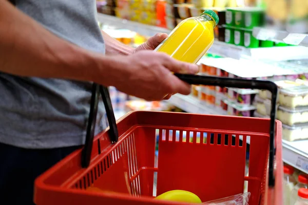 man buys food, row of shelves with groceries in a supermarket, marketing concept, prices for consumer goods, consumer basket