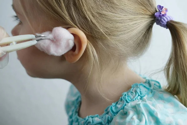 close-up of ear of small child, doctor treats otitis media, concept of hearing organs health, happy childhood, prevention of otitis media and hearing loss, World Hearing Day