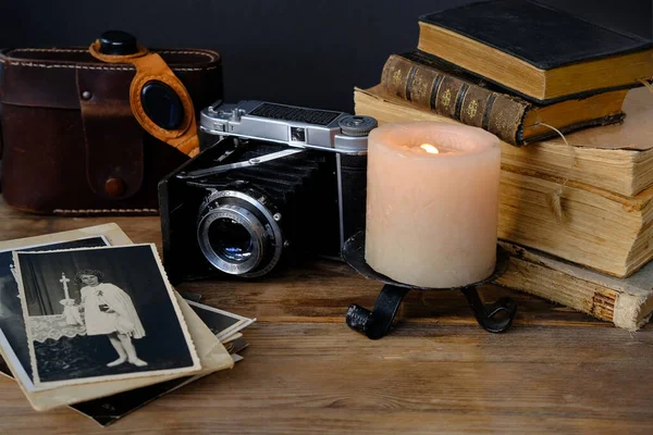 old family photos 50s, 40s, retro camera, books, glasses for solar eclipse on wooden table, concept of genealogy, memory of ancestors, family tree, childhood memories, home archive