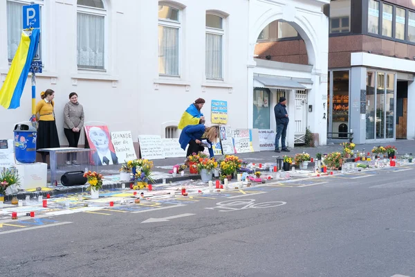 stock image Frankfurt - March 2022: people support Ukraine, flowers lie on ground, mourning candles burning for dead, an anti-war rally near Consulate General of Russian Federation, concept is no war