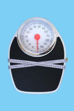 isolated on background floor mechanical scales, scale with red arrow, centimeter measuring tape, top view, the concept of weight control, human physical health, diet and nutrition, lose weight
