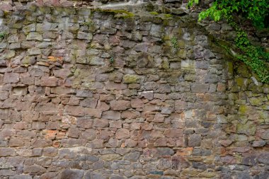 beautiful vintage texture of the wall of a medieval castle built in middle of 14th century, multi-colored volumetric stones for designer, wallpaper, rough sandy texture. Background for designer