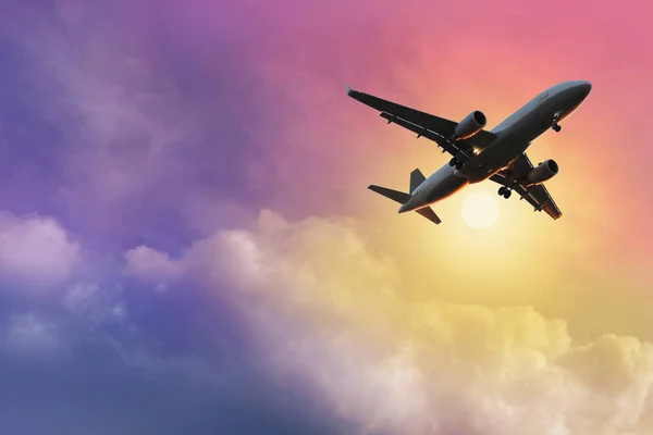 black silhouette of airplane in beautiful colorful dramatic sky with cloud, handsome sunset, concept flight in heavenly space, meditative calmness, international transportation, cargo transportation