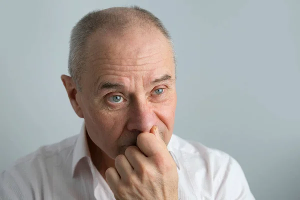 close-up of mature charismatic man, senior 60 years surprised, puzzled, shocked by news, event, bright facial expressions, overhang, concept human health, mood, human stress resistance