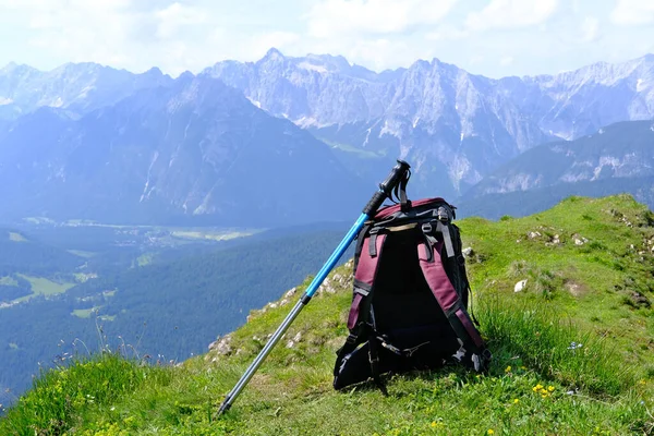 tourist backpack, trekking poles for alpine walking on the top of the mountain, on the crest of the pass, concept trekking, climbing and hiking in the mountains, Hiking in Alps, nordic walking