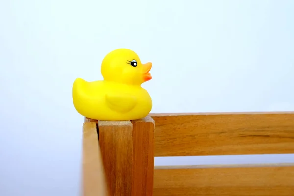 Rubber Yellow Duck Swimming Children Toy Edge Wooden Box Concept — Stockfoto