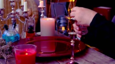 andle lights in dark room of future fortuneteller, esoteric Oracle, session of magic, divination for the future, activity at halloween party, prophecies from the world of spirits