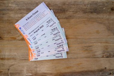 many tickets for day, for one trip, 9-euro travel subscription lies on table, monthly travel passes in germany for public transport, travel concept, in german, Frankfurt - August 2022 clipart