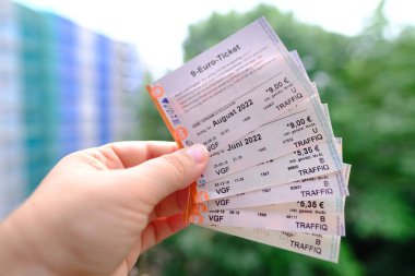 closeup female hands hold many tickets, monthly travel passes in germany for all modes of public transport, travel concept for country, in german: 9 euros - ticket, Frankfurt - August 2022