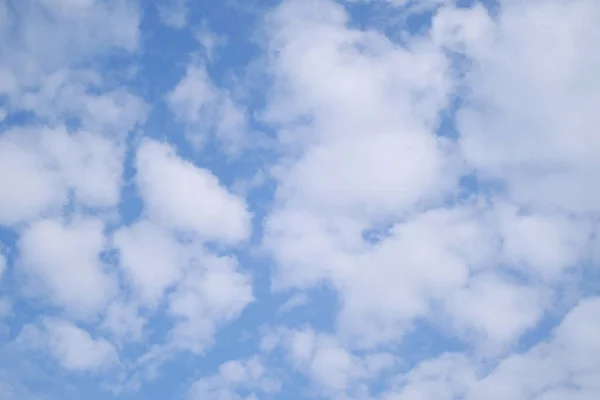 beautiful blue sky with white fluffy clouds, sun rays illuminate heavenly landscape, concept natural, seasonal, divine love, eternity