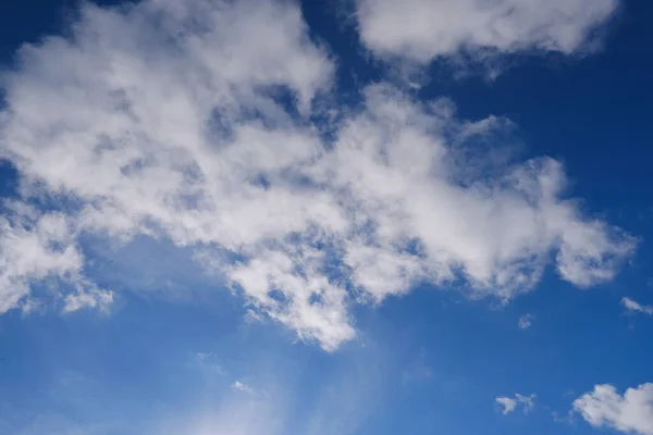 beautiful blue sky with white fluffy clouds, sun rays illuminate heavenly landscape, concept natural, seasonal, natural skyscapedivine love, eternity