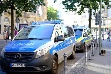 police cars on streets of germany, law enforcement officers guarding order on vehicles, patrolling, sending law enforcement officers to incident or crime, investigating crimes, Frankfurt - August 2022