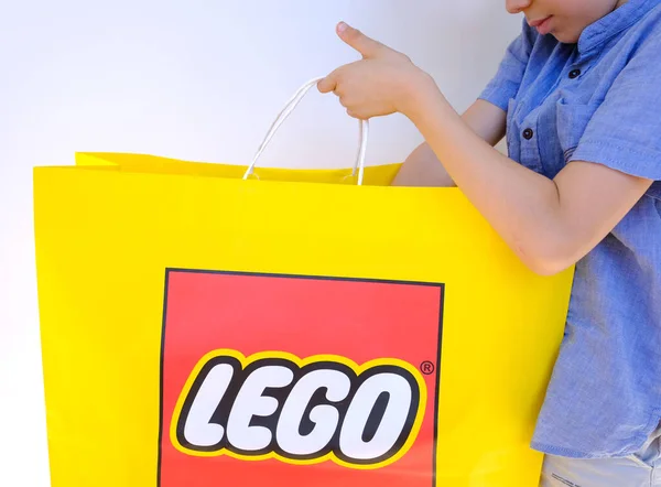 Branded Yellow Paper Bag Lego Group Corporation Logo Hands Child — Zdjęcie stockowe