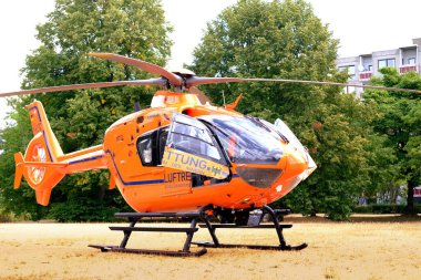 modern Red paramedic ambulance emergency aircraft Germany on helipad, medical helicopter, Air medical services, Rapid Response Vehicles, intensive care on board, Frankfurt, Germany - September 2022