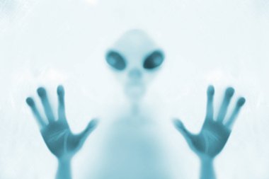 eerie blurry image of humanoids from other planets, frightening creatures that appear as if they have been trapped behind glass, dense fabric, wrap, alien trying to reach out from afterlife