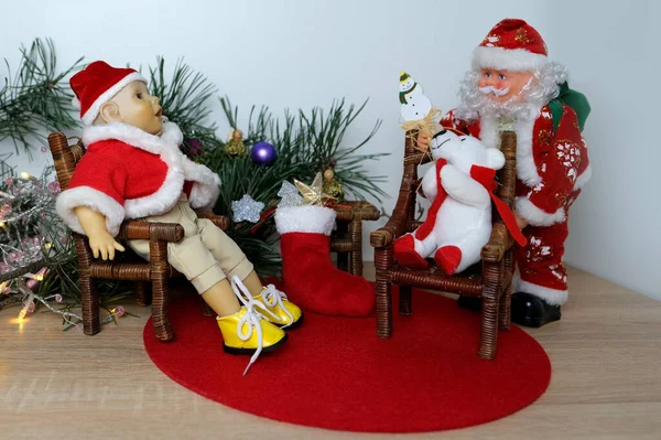 doll Santa Claus with a beard, doll boy in a red cap in smart clothes, plush polar bear, concept children\'s toy, doll fashion, hobby, for girls, happy childhood, New Year and Christmas