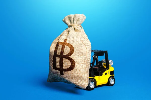 A forklift carrying a thai baht money bag. Borrowing on capital market. Strong financial assistance, business support. Investments. Subsidies soft loans. Anti crisis budget. Stimulating economy.