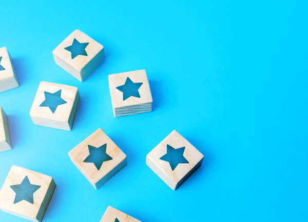 Scattered star blocks on a blue background. Popularity and fame. Feedback. Inspection, review. Benefits, positive things. New features. Ratings and reviews. Parties and celebrate events.
