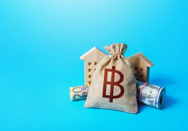 Houses and thai baht money bag. Asset, financial resource management. Declaration, taxes payment. Building up capital, saving from inflation risks. Real estate. Savings. Bookkeeping and accounting