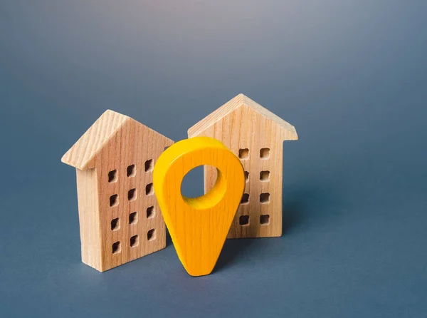 Yellow geo location pin and two houses. Tracking, city navigation internet of things. Location concept, settlement. Search for housing options. Infrastructure and surroundings. Local searching.