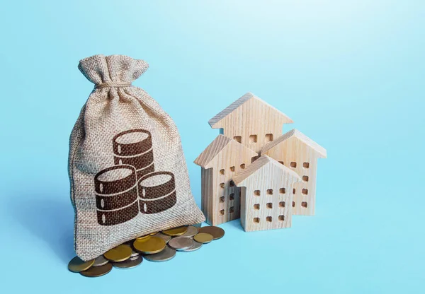 Houses and coin money bag. Real estate investment and rental business. Fair market price. Increasing property value. Home taxation. Residential or commercial property income. Municipal budget.