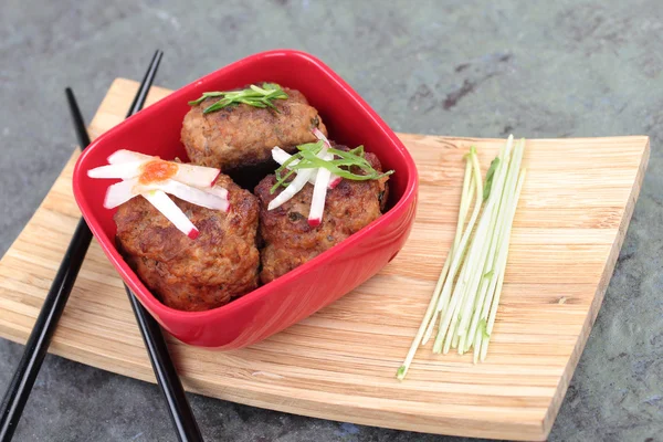 Three Asian Meatballs in a red bowl — Stock Photo, Image