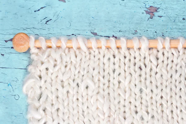 White knitting on rustic background — Stock Photo, Image