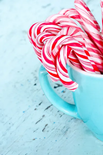 Candy canes in a light blue cup — Stock Photo, Image